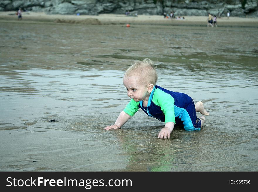 Small child exploring a beach in Cornwall. Small child exploring a beach in Cornwall.