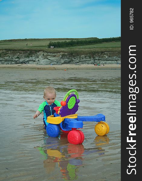 Small child exploring a beach in Cornwall. Small child exploring a beach in Cornwall.