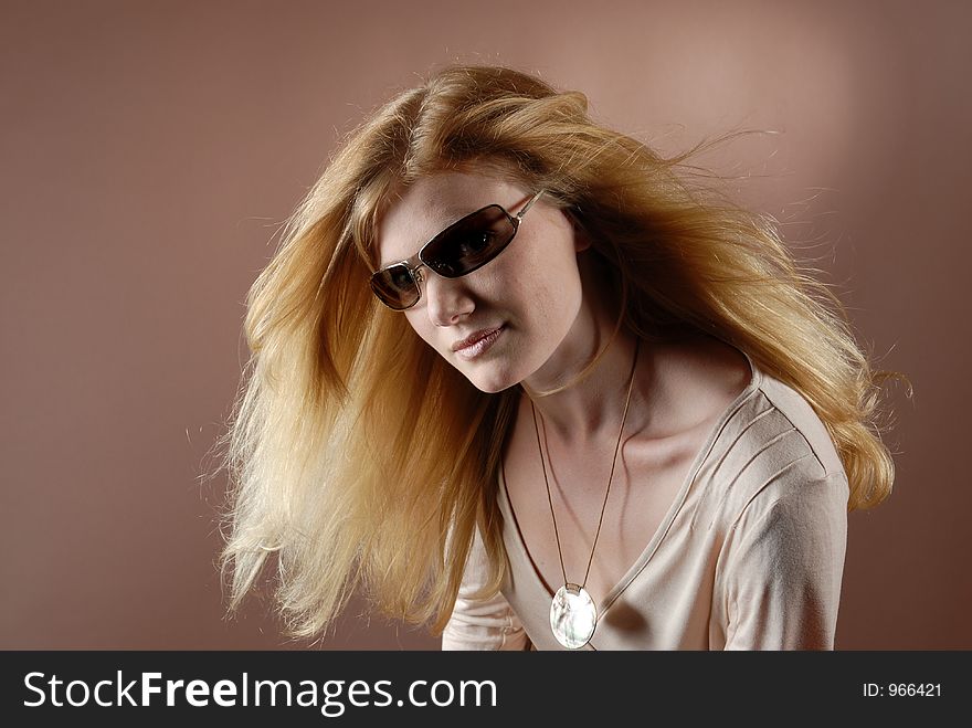 Beautyful fashion girl with sun glasses and waving long red blonde hair. Beautyful fashion girl with sun glasses and waving long red blonde hair