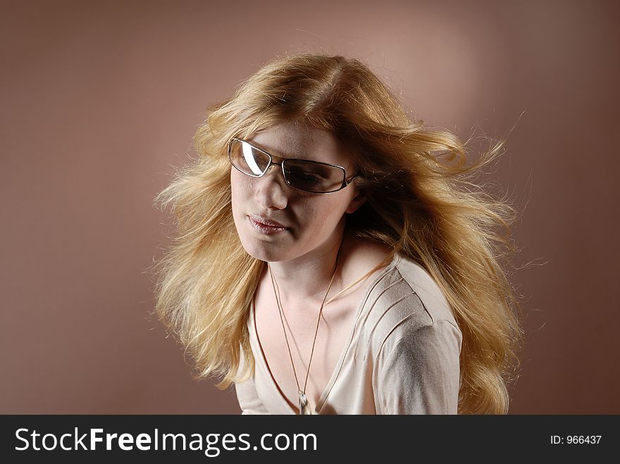 Beautyful fashion girl with sun glasses and waving long red blonde hair. Beautyful fashion girl with sun glasses and waving long red blonde hair