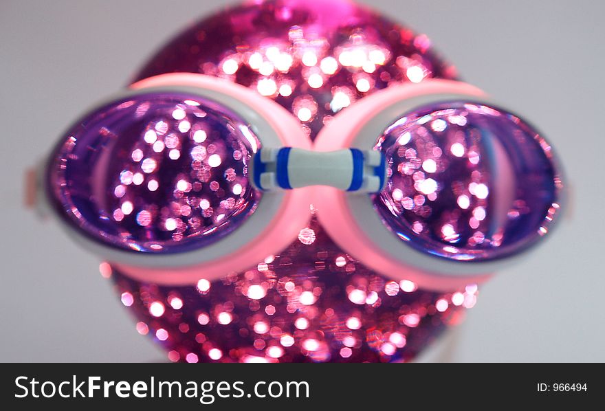 Goggle over a lighted globe. Goggle over a lighted globe