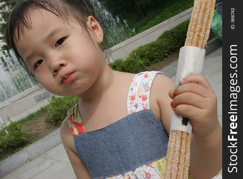 Young Korean girl eating a snack. Young Korean girl eating a snack