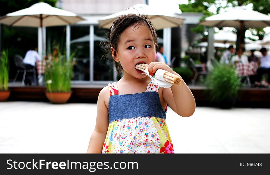 Young Asian Girl Having A Snack