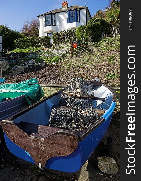 Fishing dinghy pulled up in front of fishermans house. Fishing dinghy pulled up in front of fishermans house.