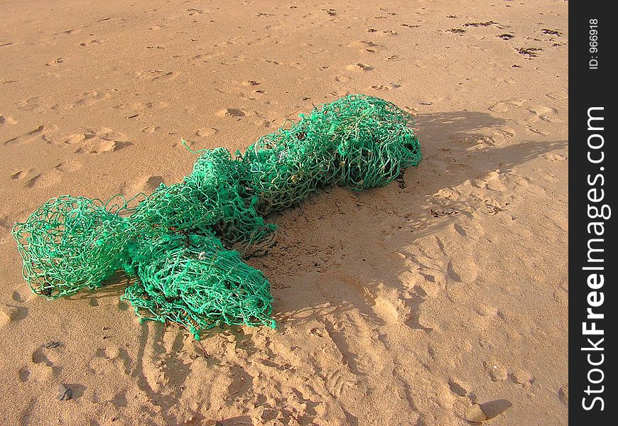 Discarded net washed up on the beach. Discarded net washed up on the beach.