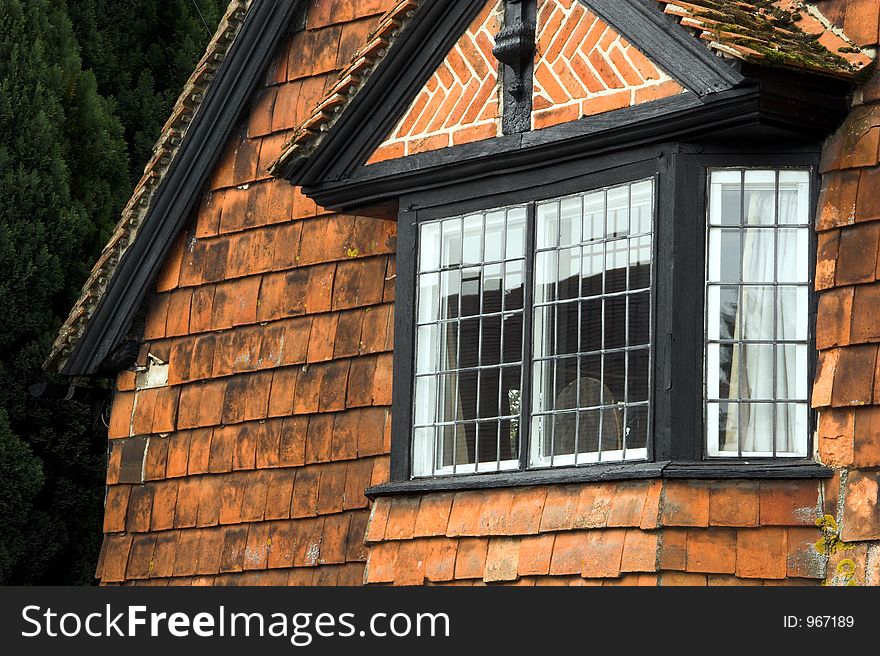 Old bay window in clay tile gable