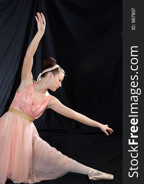 A ballet dancer poses in classic ballet pose. A ballet dancer poses in classic ballet pose