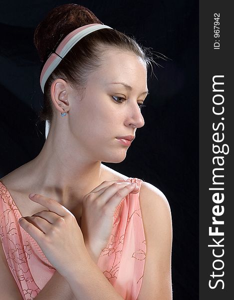 A close up view of a ballerina with hands posed at neck-line. A close up view of a ballerina with hands posed at neck-line