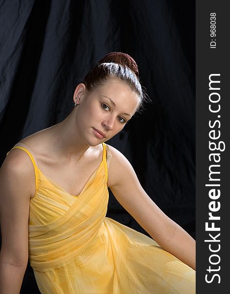 Portrait of a ballerina at rest in a yellow ltrical costume, portrait is half length. Portrait of a ballerina at rest in a yellow ltrical costume, portrait is half length