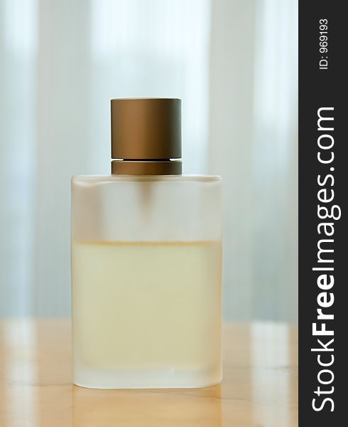 Perfume bottle resting on wooden table