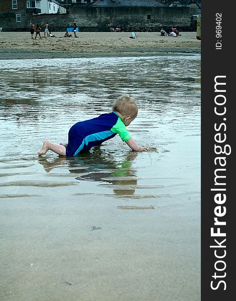 Small child exploring a beach in Cornwall. Small child exploring a beach in Cornwall.