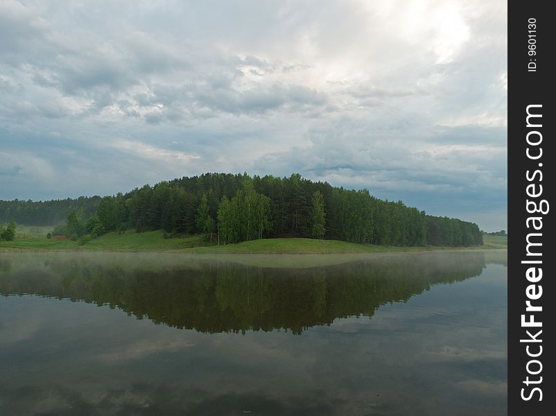 Early morning, view of the lake after the rain. Beautiful reflection of the forest in the water.
Russian Nature, Spring 2009.