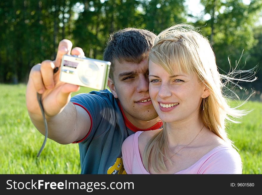 Happiness couple in love with digital camera smiling. Happiness couple in love with digital camera smiling