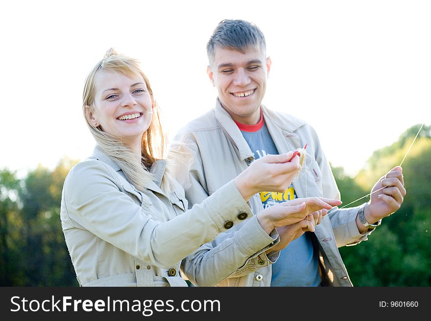Happy young couple in love flying a kite