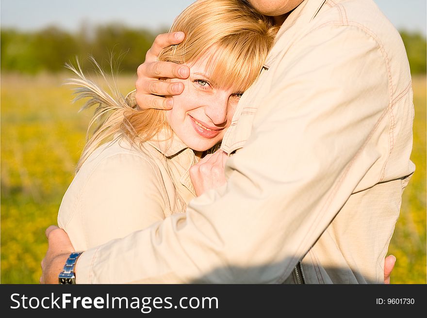 The loving couple embraces. Close-up portrait of smiling girl in love