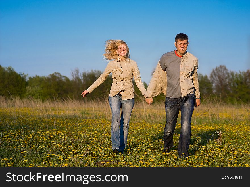 Happy couple walk across the field. Happy couple walk across the field