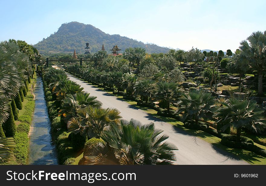 Road and channel leaving in distance in palm path to temple and grief