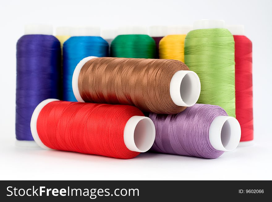 Hanks of multi-coloured threads for embroidery on a white background