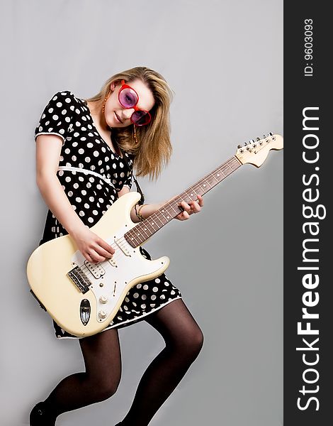 Young girl playing guitar isolated