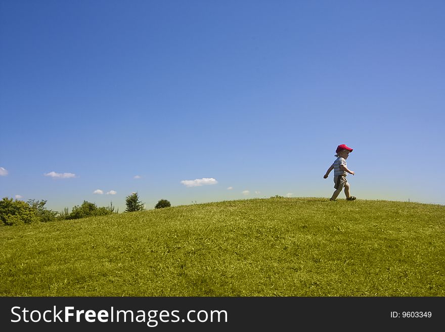 2 year old toddler on hill in summer. 2 year old toddler on hill in summer