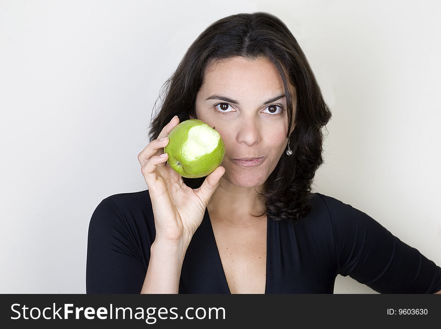 Young woman holding a green apple. Young woman holding a green apple