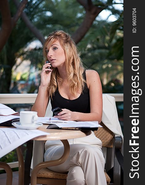 Young attractive businesswoman working in a restaurant terrace