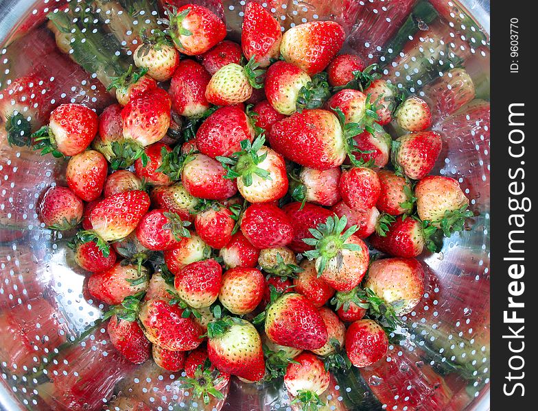 Strawberries after washing in strainer. Strawberries after washing in strainer