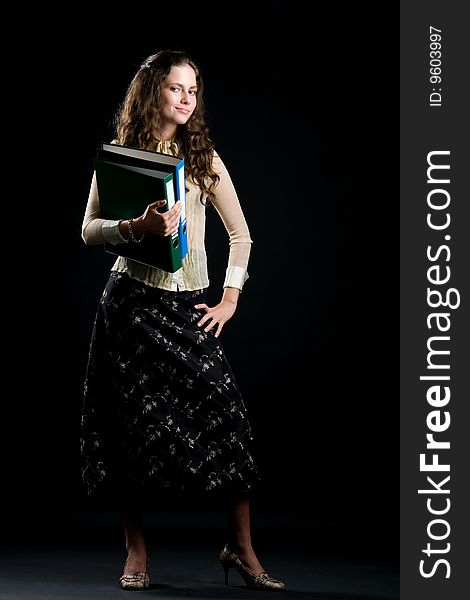 Photo of the woman with folders on a black background. Photo of the woman with folders on a black background