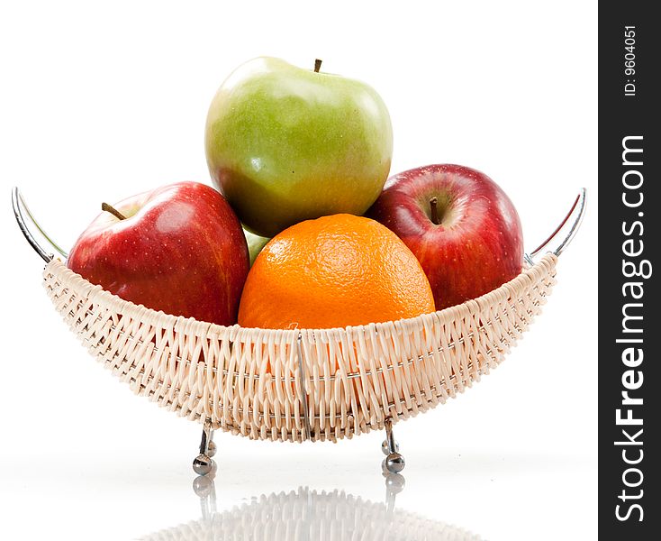 Wicker vase with apples and oranges. Wicker vase with apples and oranges