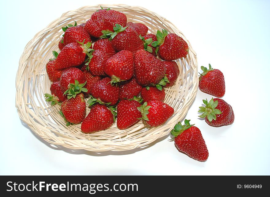A strawberry in wicker plate. A strawberry in wicker plate.