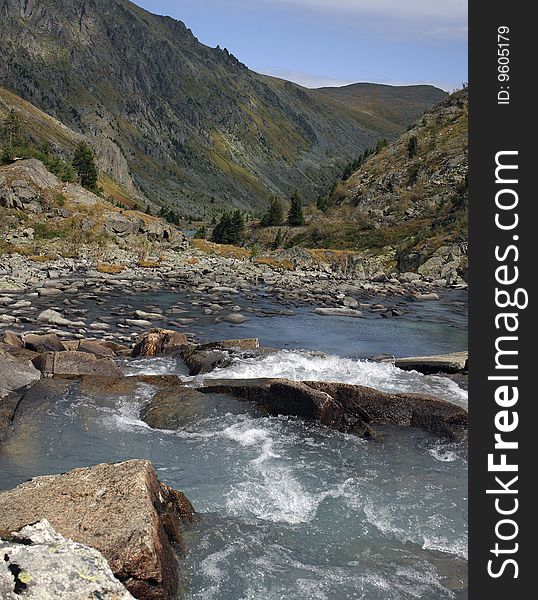 Stream of the river among large stones, high rocks, the mountains, separate cedars. Stream of the river among large stones, high rocks, the mountains, separate cedars.