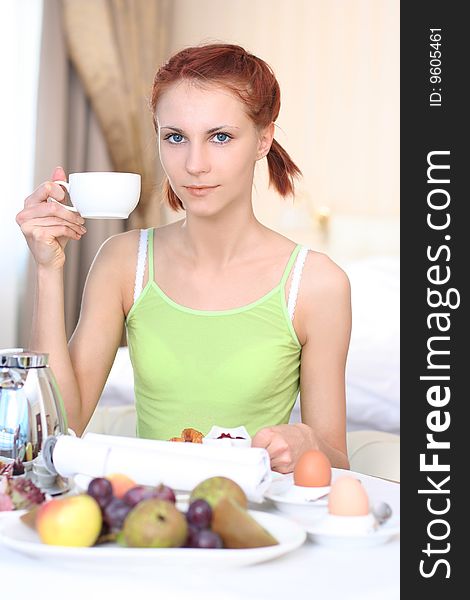 Cute young woman having breakfast. Cute young woman having breakfast