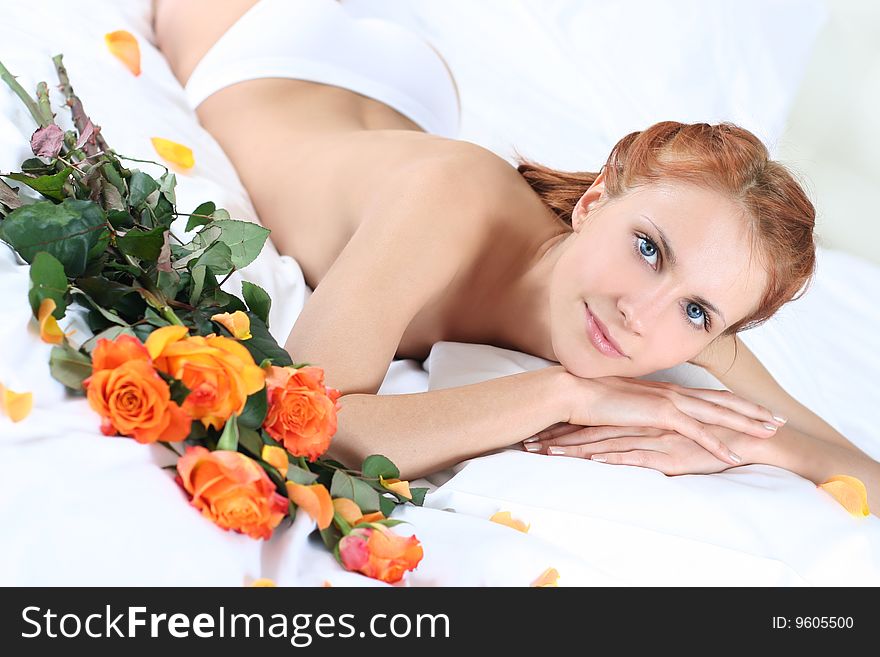 Cute young woman lying on bed. Cute young woman lying on bed