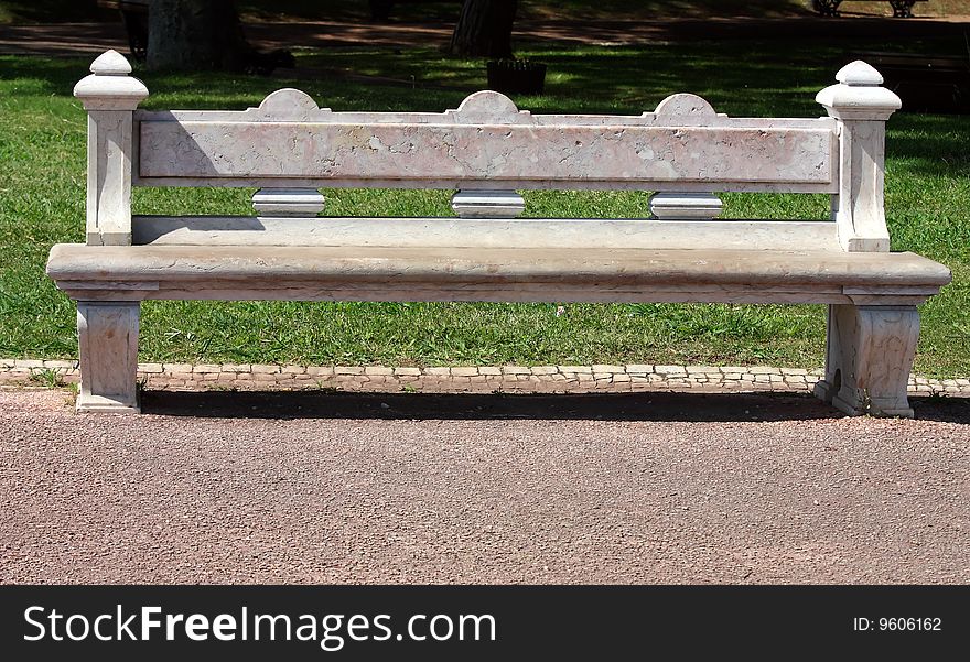 Carved stone park bench in garden. Carved stone park bench in garden