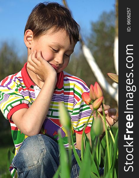 Little boy with tulips outdoors