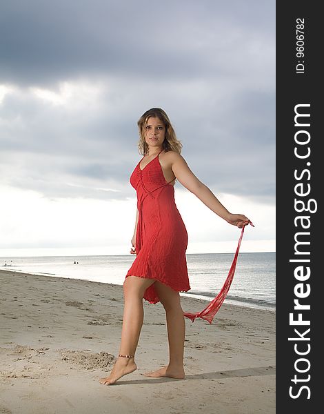 Girl with red dress in the beach. Girl with red dress in the beach