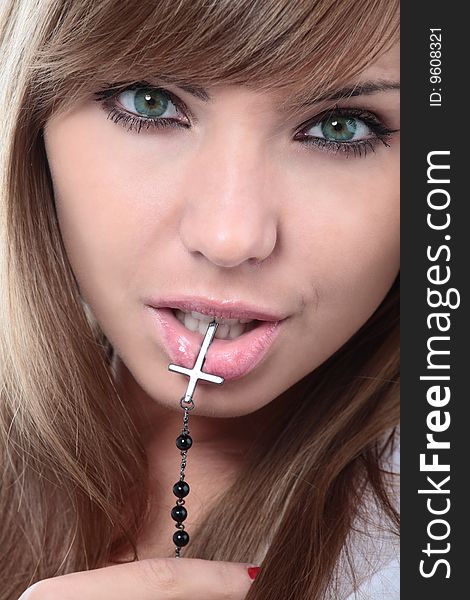 Close-up portrait of young beautiful woman with crucifix. Close-up portrait of young beautiful woman with crucifix