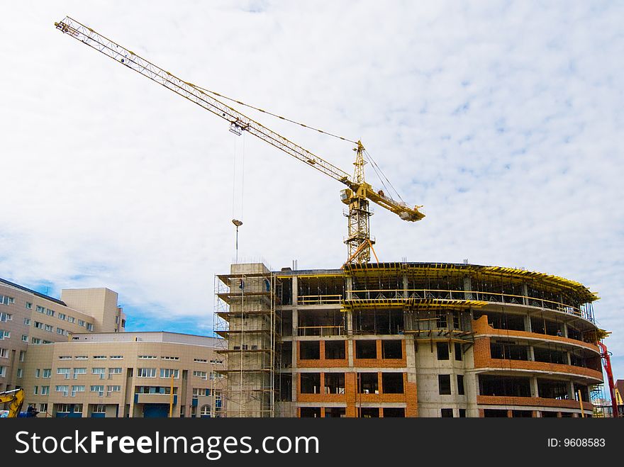 Building crane and half-built house