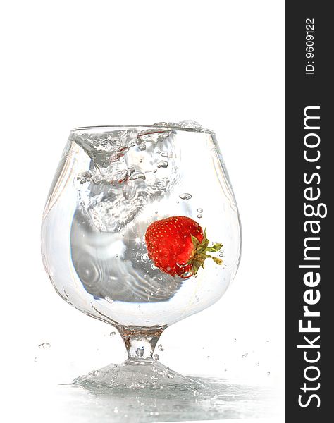 Strawberry inside goblet of splashing water isolated on white background with clipping path. Strawberry inside goblet of splashing water isolated on white background with clipping path