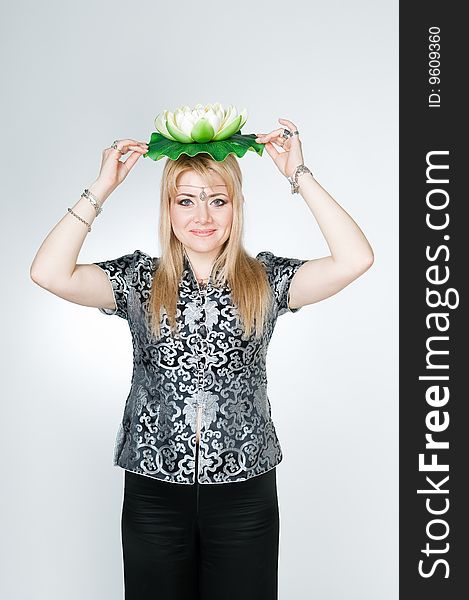 Beautiful woman with lotus flower, studio shot