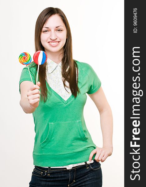 Smiling girl with lollipops, focus on sweets