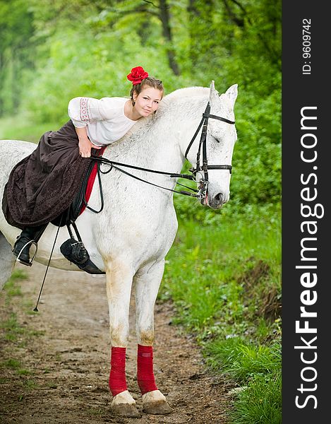 Beautiful girl with horse in the forest