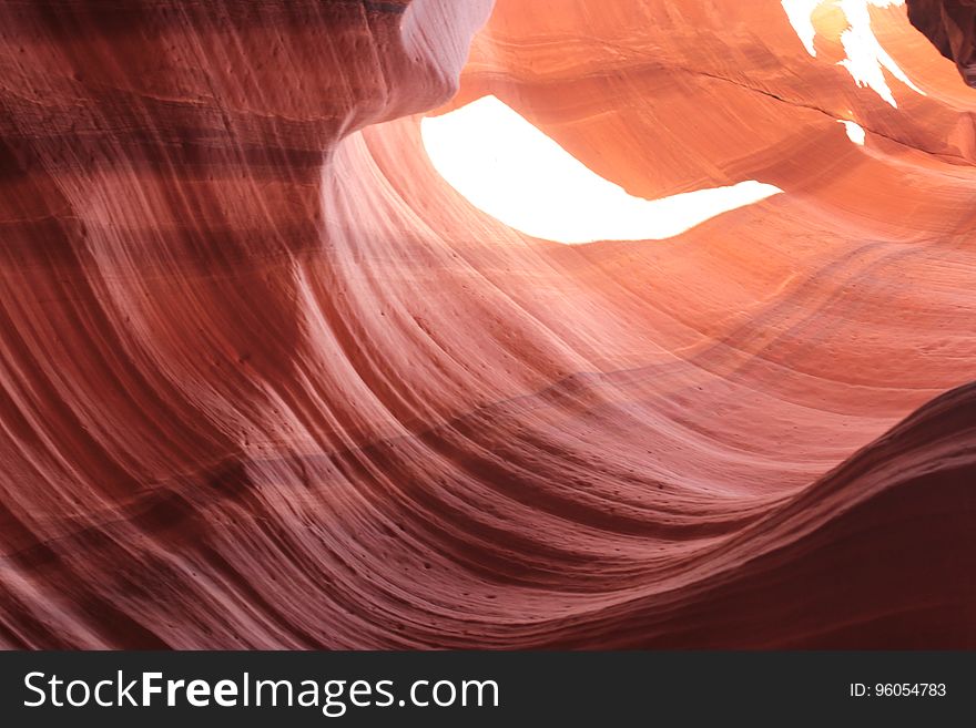 Abstract textured background created by red sandstone canyon eroded by river or stream.