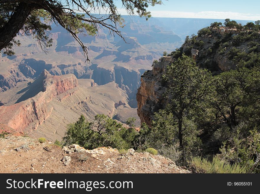 Scenic view of mountainous desert landscape with trees in foreground.