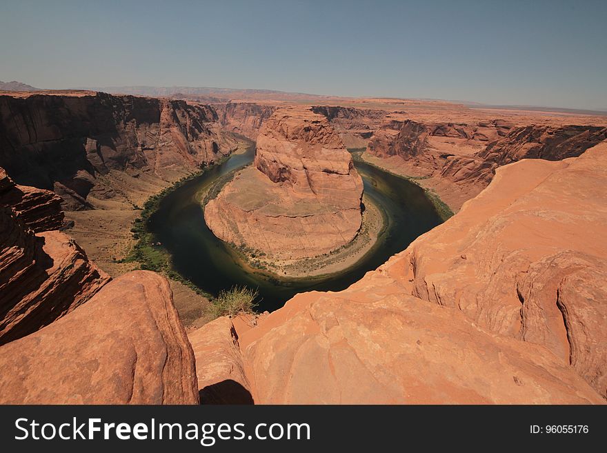 A lake with an islet in a desert canyon. A lake with an islet in a desert canyon.