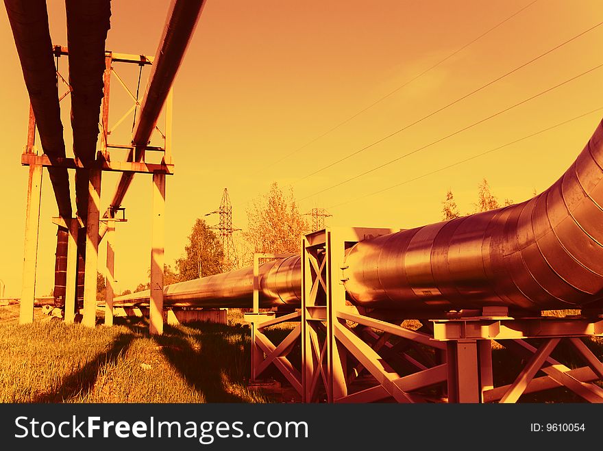 Industrial pipelines on pipe-bridge against blue sky. Industrial pipelines on pipe-bridge against blue sky.