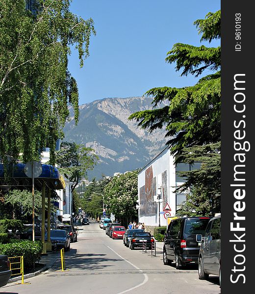 Street of city on a background mountains and dark blue sky in Crimea. Street of city on a background mountains and dark blue sky in Crimea.