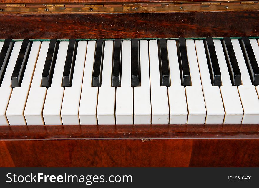 Black and white keys of old piano closeup