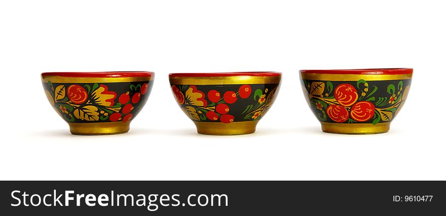 Three painted Russian khokhloma wooden cups isolated. Three painted Russian khokhloma wooden cups isolated