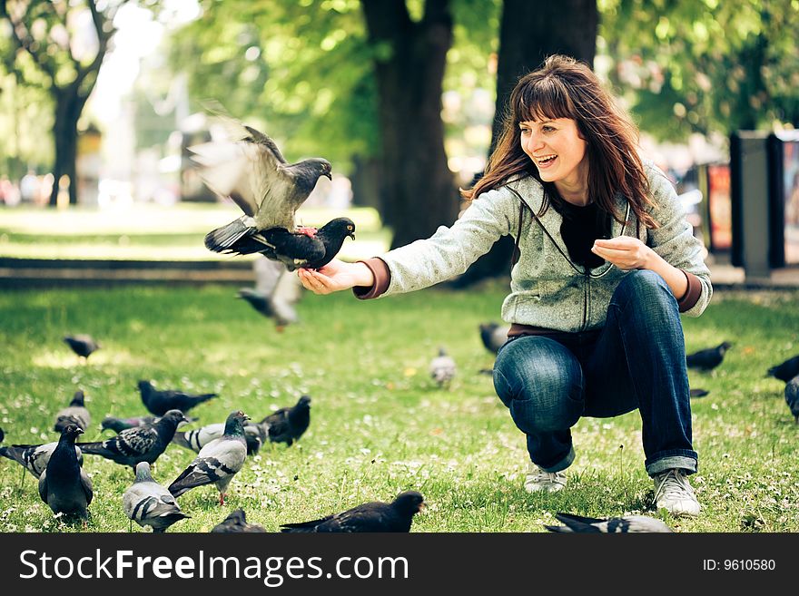 Happy woman with doves in the park